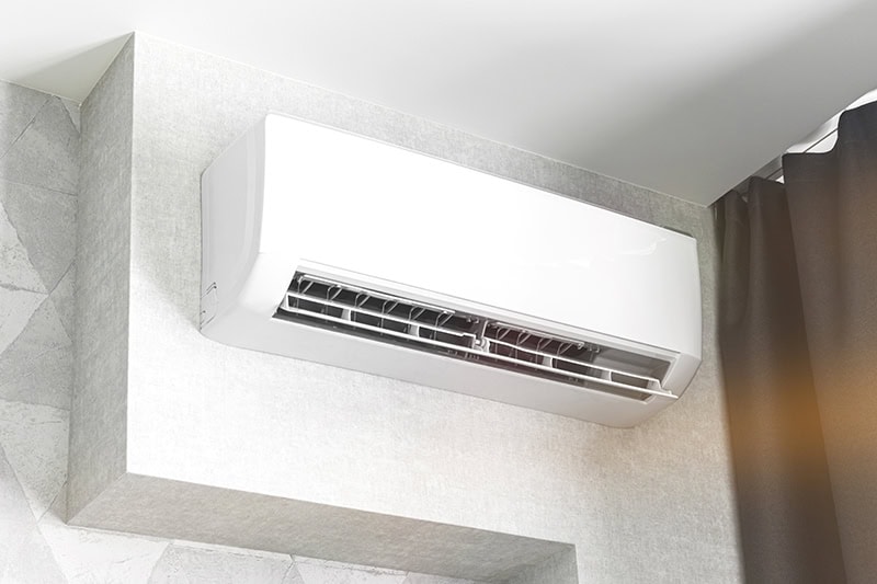 A white ductless unit on a white wall