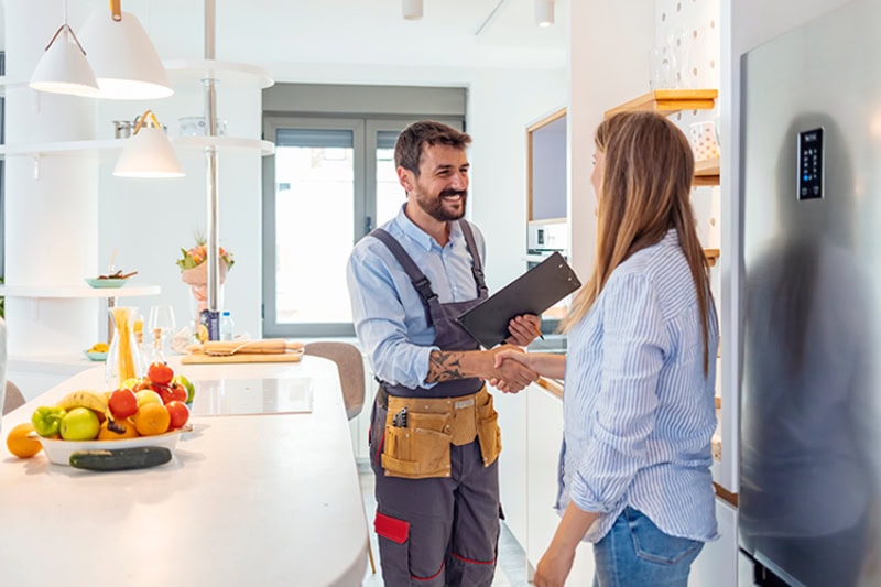 A woman shaking hands with an electrician