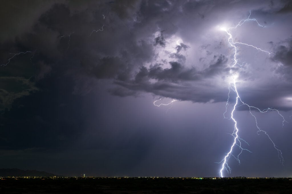 Lightning strike in a thunderstorm Powerful lightning strike from a monsoon thunderstorm in Arizona.