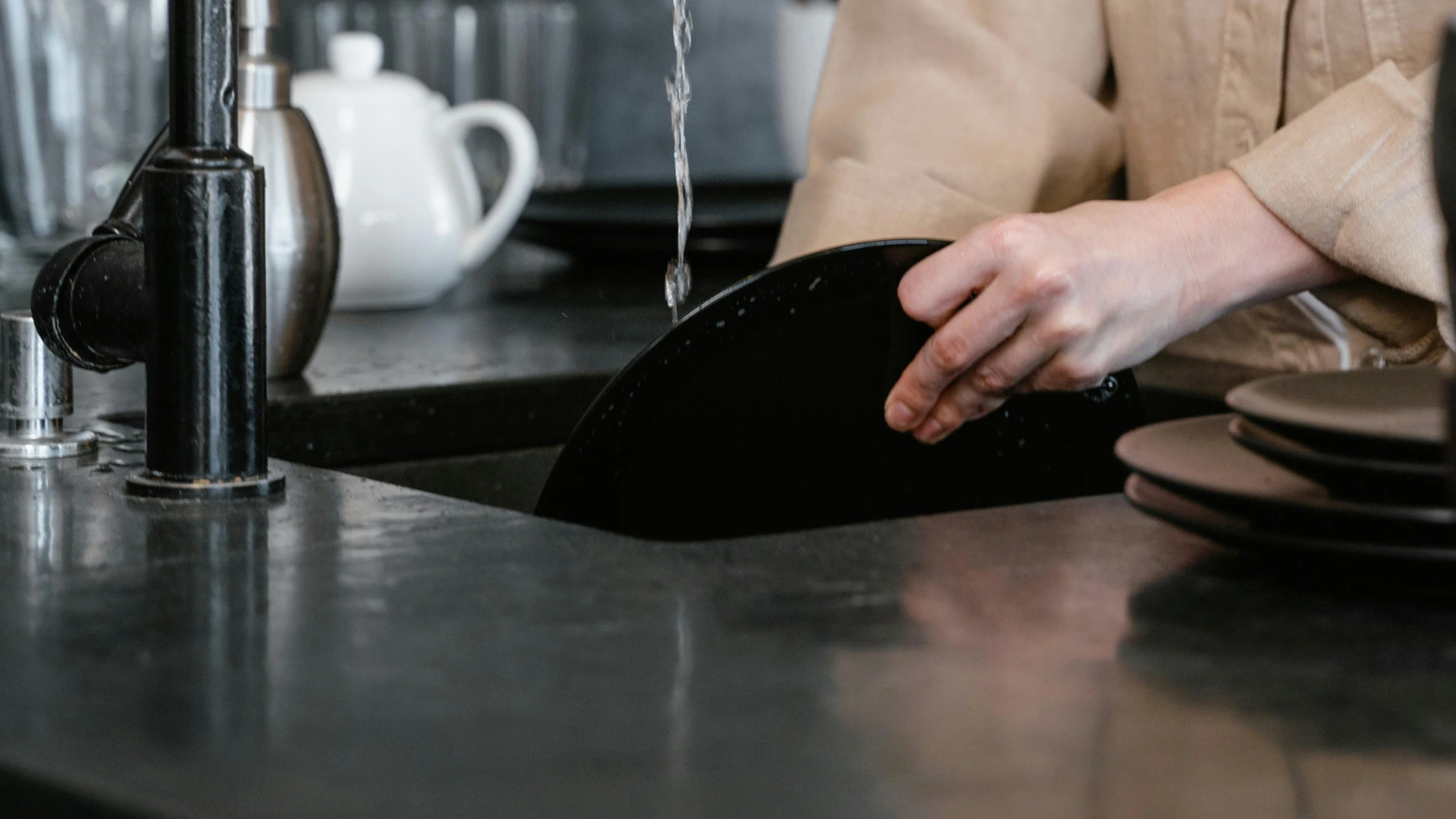 photo of doing dishes in black sink